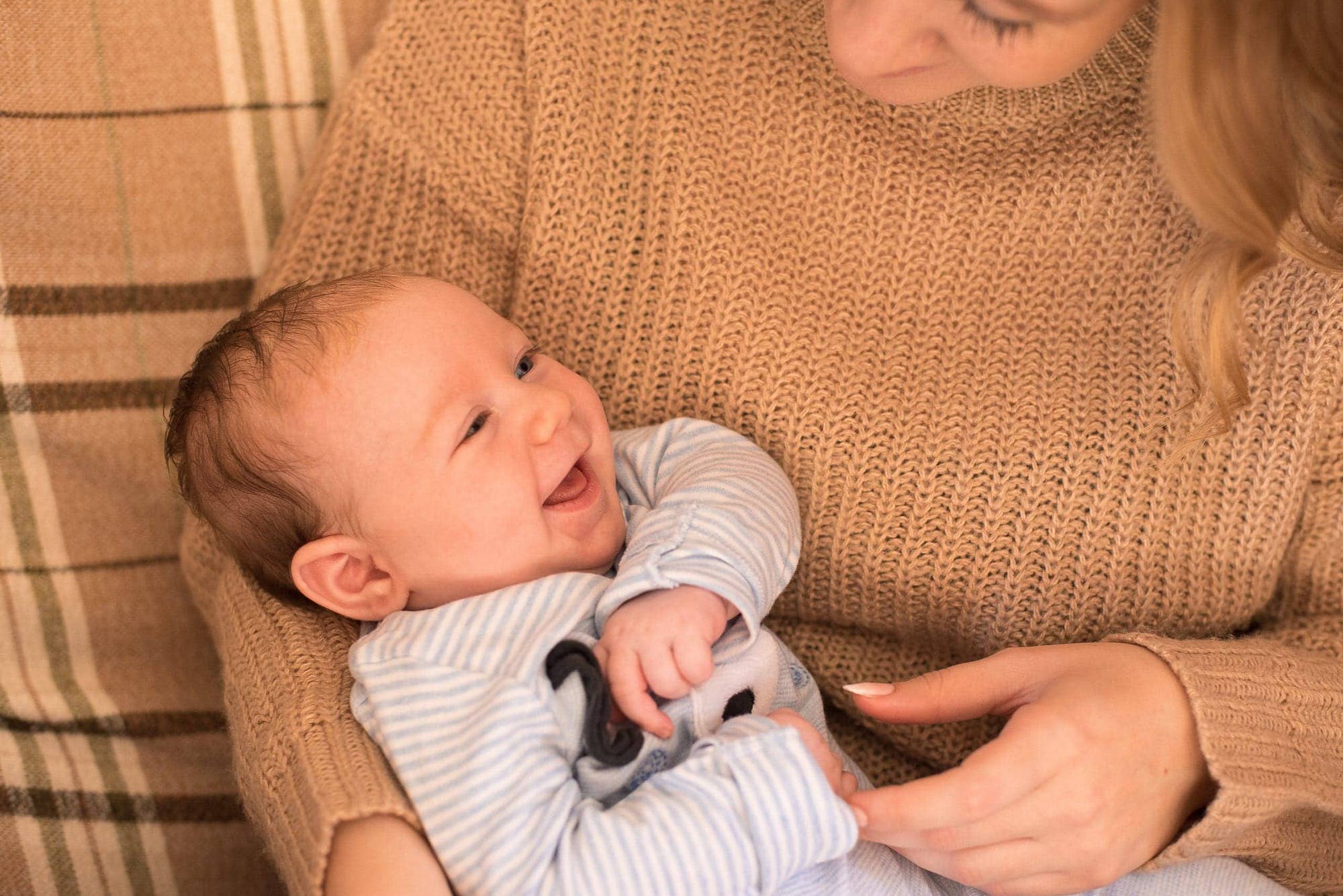 laughing baby boy in his mothers arms, norfolk