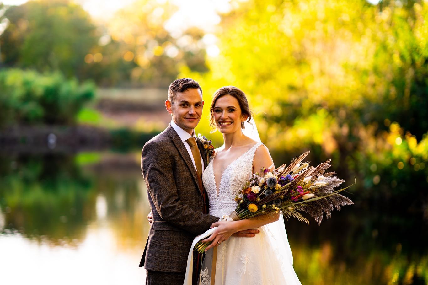 Bride and groom by the lake at Worstead estate